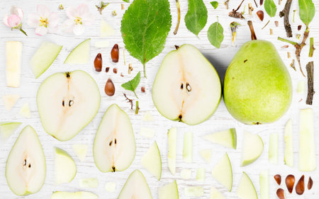 Abstract background made of Pear fruit pieces, slices and leaves on wooden background.の写真素材