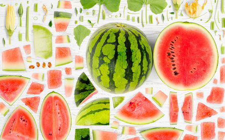 Abstract background made of Watermelon fruit pieces, slices and leaves on wooden background.の写真素材