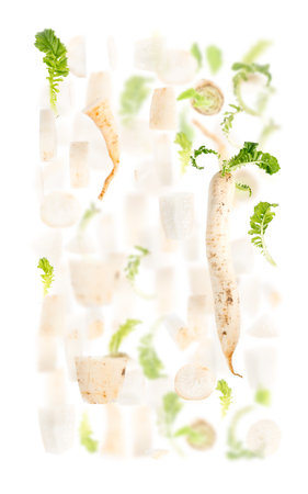 Abstract background made of Parsley root vegetable pieces, slices and leaves isolated on white.の写真素材