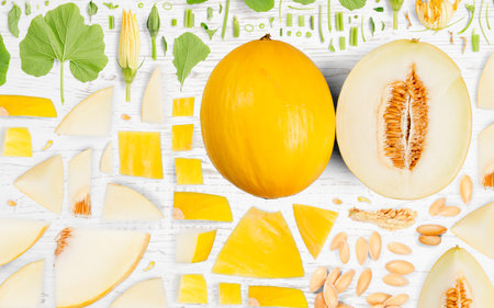Abstract background made of Sugar Melon fruit pieces, slices and leaves on wooden background.の写真素材