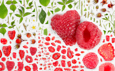 Abstract background made of Raspberry fruit pieces, slices and leaves on wooden background.の写真素材