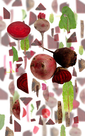 Abstract background made of Red Beet vegetable pieces, slices and leaves isolated on white.の写真素材