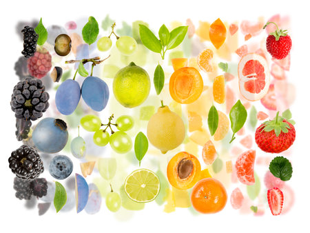Abstract made of Fruit piece and slice group. Colors going from black, blue, green, yellow and orange to red. Vertical composition, white background.の写真素材