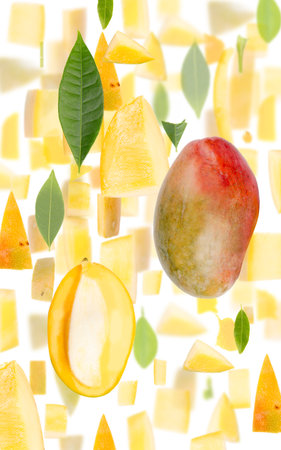 Abstract background made of Mango fruit pieces, slices and leaves isolated on white.の写真素材