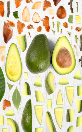 Avocado fruit piece, slice and leaf collection. Flat lay, seamless abstract on wooden background.の写真素材