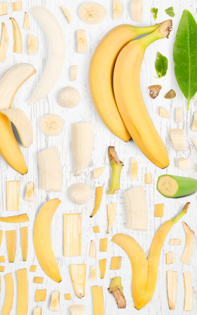 Banana fruit piece, slice and leaf collection. Flat lay, seamless abstract on wooden background.の写真素材