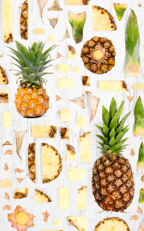 Pineapple fruit piece, slice and leaf collection. Flat lay, seamless abstract on wooden background.の写真素材