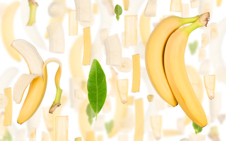 Abstract background made of Banana fruit pieces, slices and leaves isolated on white.の写真素材
