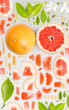 Grapefruit fruit piece, slice and leaf collection. Flat lay, seamless abstract background on gray background.の写真素材