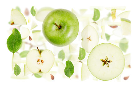 Abstract background made of Green Apple fruit pieces, slices and leaves isolated on white.の写真素材