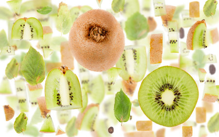 Abstract background made of Kiwi fruit pieces, slices and leaves isolated on white.の写真素材