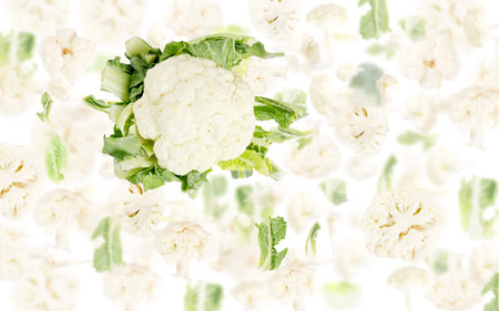 Abstract background made of Cauliflower vegetable pieces, slices and leaves isolated on white.の写真素材