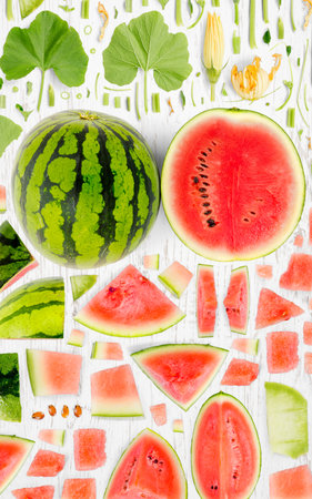 Abstract background made of Watermelon fruit pieces, slices and leaves on wooden background.の写真素材