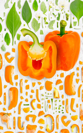 Abstract background made of Orange Pepper vegetable pieces, slices and leaves on wooden background.の写真素材