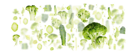 Abstract background made of Broccoli fruit pieces, slices and leaves isolated on white.の写真素材