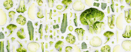 Broccoli vegetable piece, slice and leaf collection. Flat lay, seamless abstract on wooden background.の写真素材