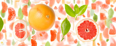 Abstract background made of Grapefruit fruit pieces, slices and leaves isolated on white.の写真素材