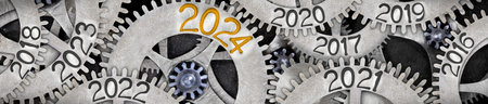Photo of tooth wheel mechanism with numbers 2024, 2023, 2022 imprinted on metal surface. New Year concept.の写真素材
