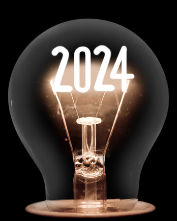 Single shining light bulb with fiber in a shape of New Year 2024 isolated on black background.の写真素材