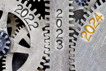 Photo of tooth wheel mechanism with numbers 2024, 2023, 2022 imprinted on metal surface. New Year concept.の写真素材