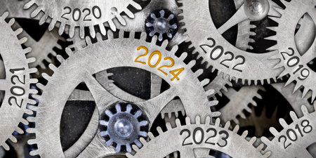 Photo of tooth wheel mechanism with numbers 2024, 2023, 2022 imprinted on metal surface. New Year concept.の写真素材