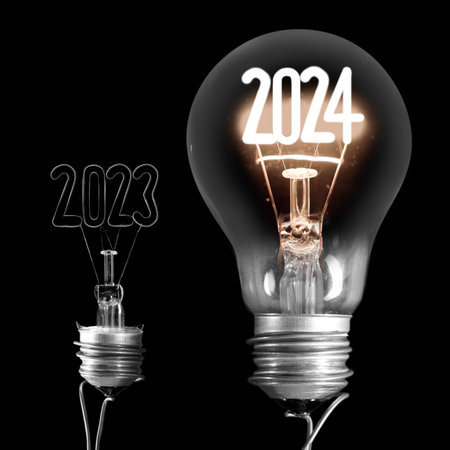 Horizontal group of shining light bulbs with fiber in a shape of New Year 2024 and dark light bulbs with years passed isolated on black background.の写真素材