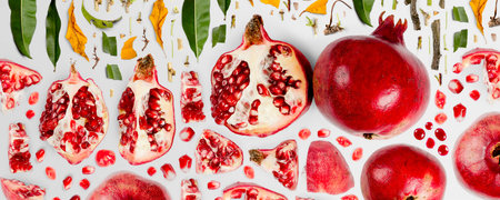 Pomegranate fruit piece, slice and leaf collection. Flat lay, seamless abstract on gray background.の写真素材