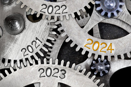 Photo of tooth wheel mechanism with numbers 2024, 2023, 2022 imprinted on metal surface. New Year concept.の写真素材