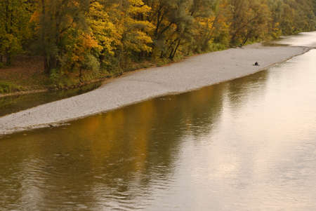 Couple Relaxing Along the Shore of the Isarの写真素材