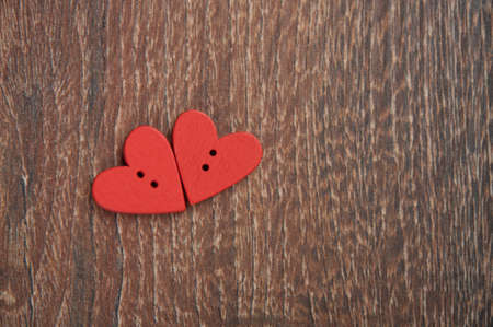 two wooden red hearts on the wooden boardの写真素材