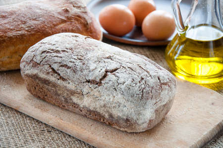 Homemade bread ciabatta on the table. Olive oil, eggs and flour 