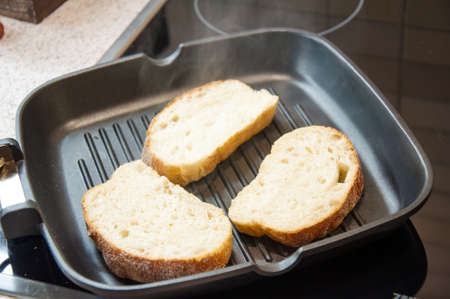 Thick slices of freshly baked garlic bread seasoned with butter の写真素材