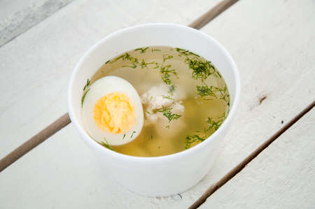 chicken soup with noodles and eggsの写真素材