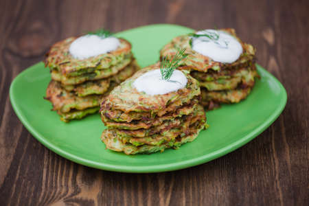 Green pancakes with zucchini and herbsの写真素材
