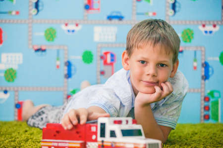 young boy playing with car in studioの写真素材