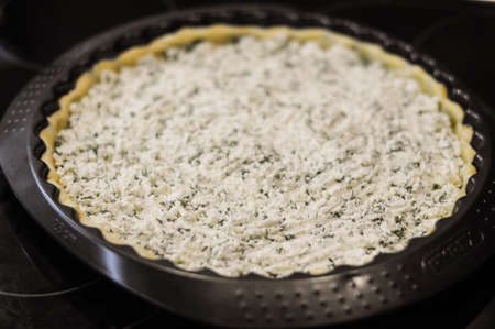 Preparation of the pie with cottage cheese,feta and parsleyの写真素材
