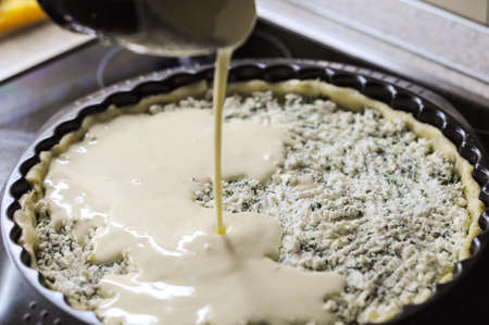 Preparation of the pie with cottage cheese,feta and parsleyの写真素材