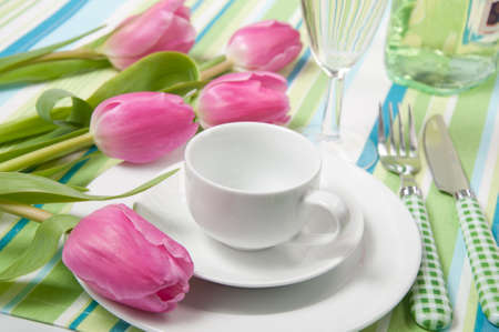 setting the table on holiday with flowers and cup of coffeeの写真素材