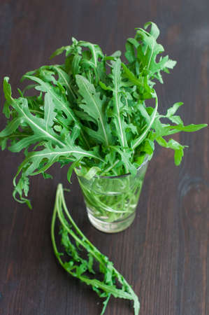 fresh ruccola leaves on wooden backgroundの写真素材