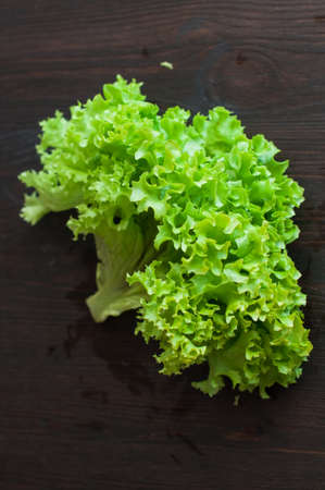 fresh green lettuce on black wooden tableの写真素材