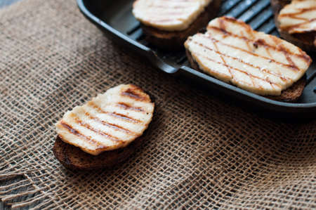 Crostini with fried cheese on the grill panの写真素材