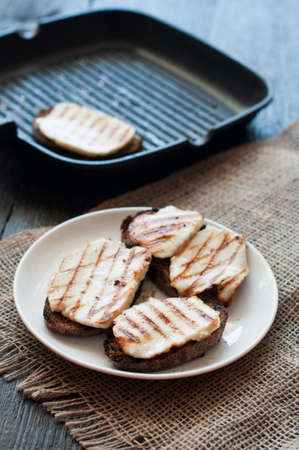 Crostini with fried cheese on the grill panの写真素材