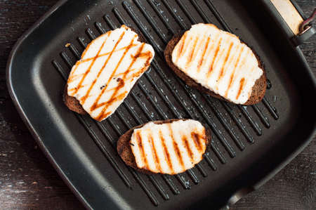 Crostini with fried cheese on the grill panの写真素材