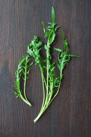 fresh ruccola leaves on wooden backgroundの写真素材