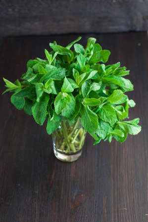 fresh mint leaves in the glass of waterの写真素材