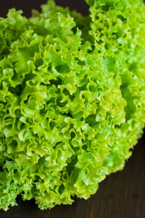 fresh green lettuce on black wooden tableの写真素材