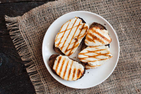 Crostini with fried cheese on the grill panの写真素材