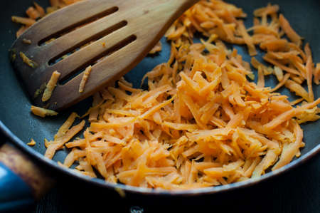 Chopped carrot in the pan and olive oilの写真素材