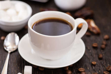 Cup of black coffee on the wooden table