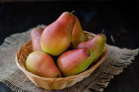 fresh pears in the plate, on the wooden backgroundの写真素材